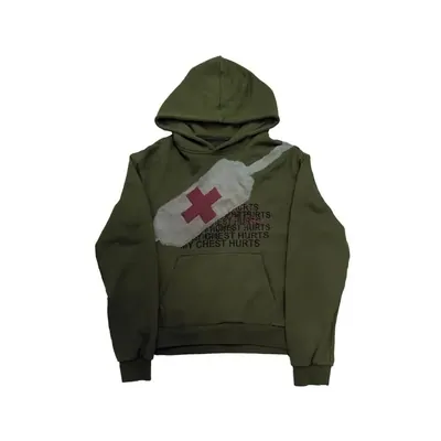 An olive green hooded sweatshirt laid flat, with a red cross graphic on the chest