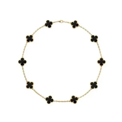 A gold-tone chain necklace set with evenly spaced black four-petal stones on white