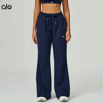 Navy wide-leg sweatpants worn by a model against a plain grey background